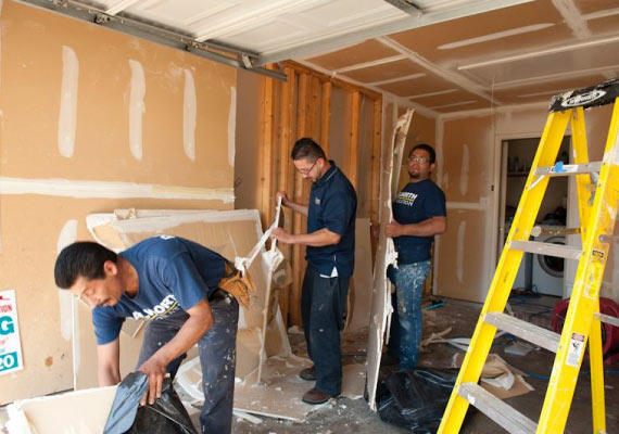 team member demolishes and removes garage