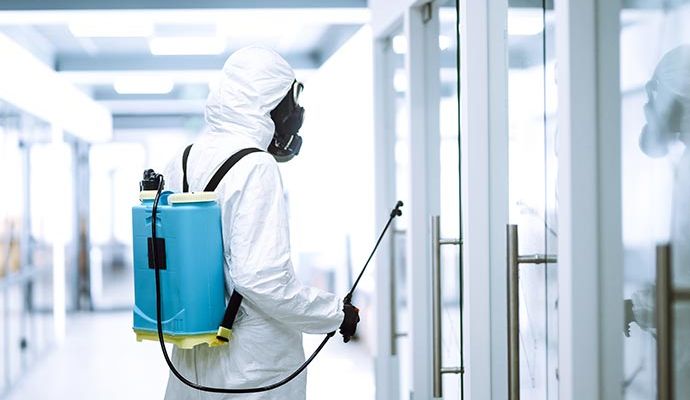 Professional performing disinfecting service in a commercial space