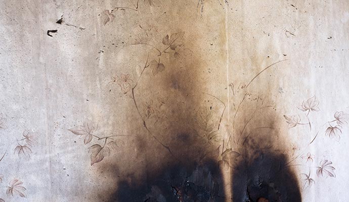 A wall with fire and smoke damage