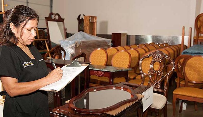 a woman writing something on a paper to provide content restoration service