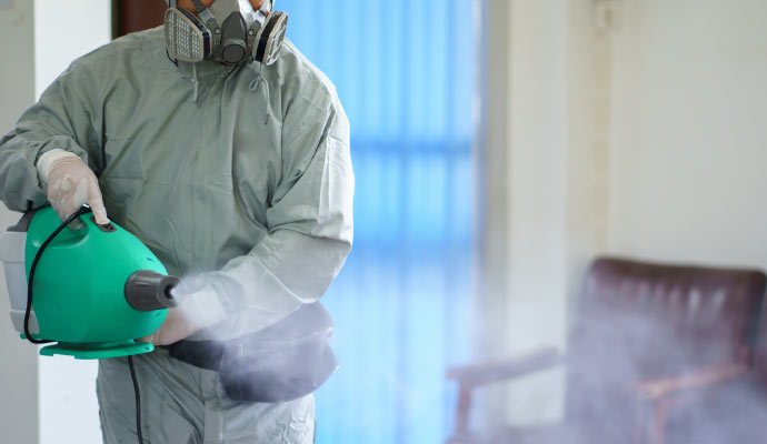 a person is disinfecting a room using disinfectant fogger